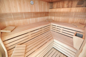 Interior of traditional wooden sauna or steam room for health benefits